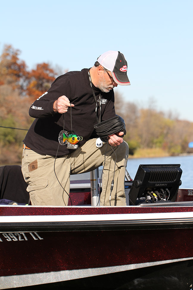 steve-pennaz-lowers-his-aquavu-camera-that-is-connected-to-his-garmin-combo-unit-into-the-water