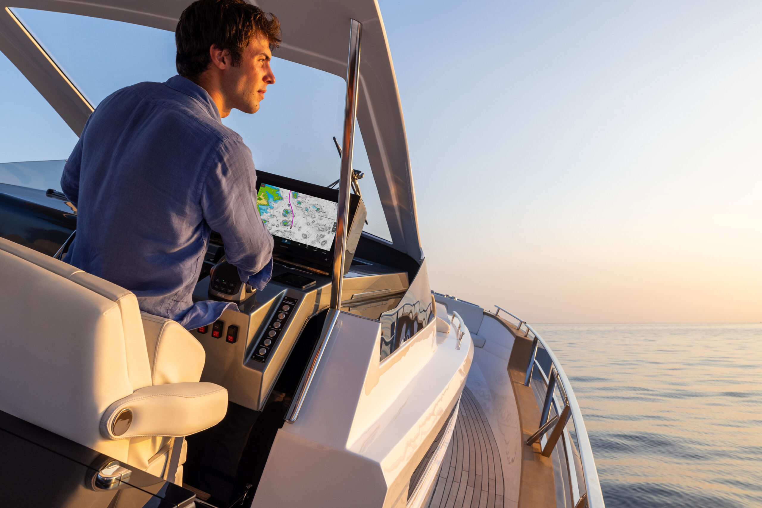 Someone at the helm using Navionics mapping on their chartplotter to navigate.