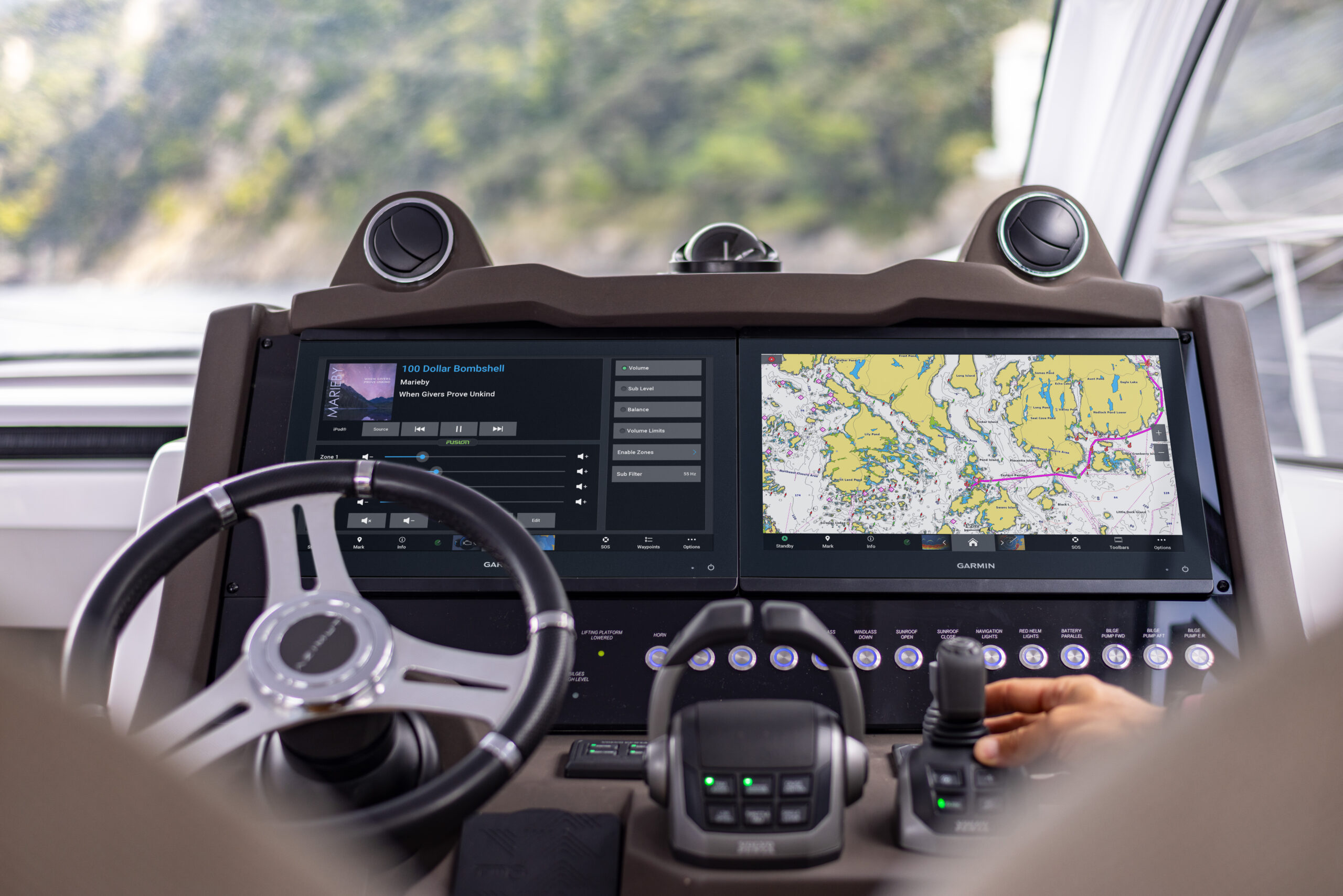 A chartplotter with marine mapping on the display screen. The chartplotter is on the dashboard to the right of the helm.