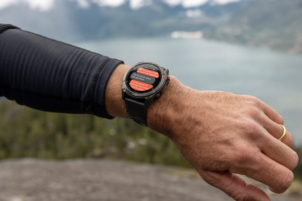 A man wearing fēnix 8 Pro checks the messages on his watch.